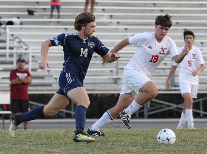 South Point's Henry Keel looks to defend East Gaston's Nick Smith on Wednesday night in Belmont. The Red Raiders defeated the Warriors 1-0. (BRIAN MAYHEW / SPECIAL TO THE GAZETTE)