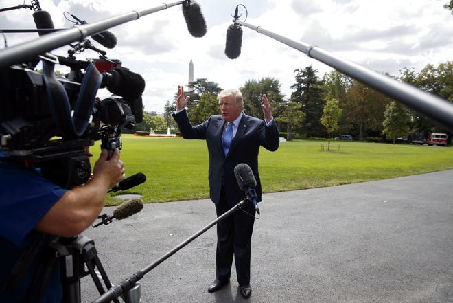 President Donald Trump talks to reporters as he walks to board Marine One on the South Lawn of the White House, Wednesday, Sept. 27, 2017, in Washington. (AP Photo/Evan Vucci)