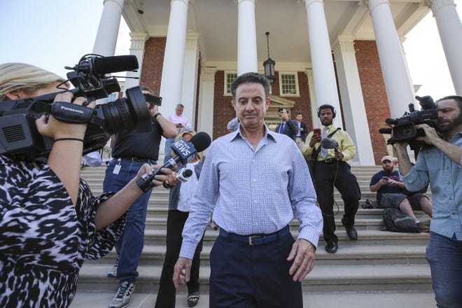 Louisville men's basketball coach Rick Pitino leaves Grawemeyer Hall after having a meeting with the university's interim president, Greg Postel, Wednesday, in Louisville. Ky. [MICHAEL CLEVENGER / THE COURIER-JOURNAL VIA AP]