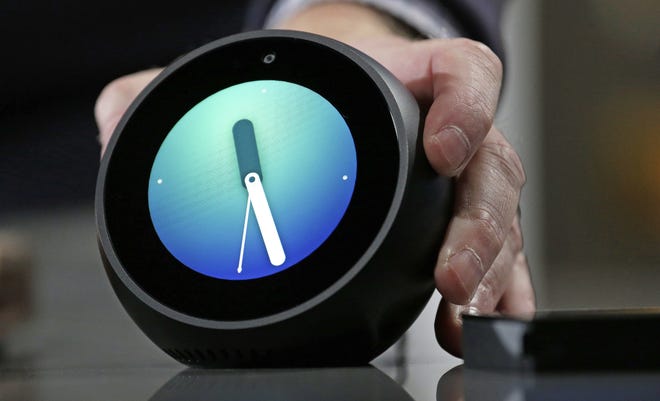 An Amazon Echo Spot is displayed during a program announcing several new Amazon products by the company on Wednesday in Seattle. The round version of the Echo Show has its own 2.5-inch display that can provide visual information, such as the weather or a clock face. It also provides access to Alexa and supports optional video-calling support.   [AP Photo / Elaine Thompson]