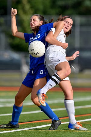 Georgetown's Casey Smith gets tangled up with Grace Evans of Ipswich as they both charge after a loose ball on Sept. 8. [Wicked Local Staff Photo / David Sokol]
