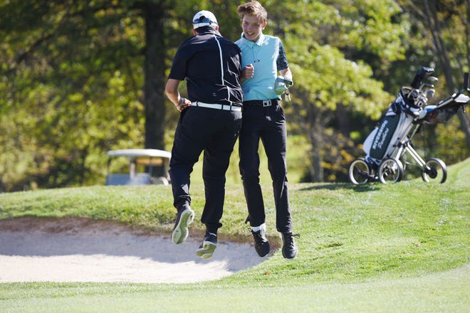 Riverside's Skyler Fox, right, leaps in celebration with fellow Riverside golfer Justin Hand after Fox edged Sewickley Academy's Cole Luther in a playoff to win the WPIAL boys AA individual golf championship at Allegheny Country Club on Thursday in Sewickley Heights.