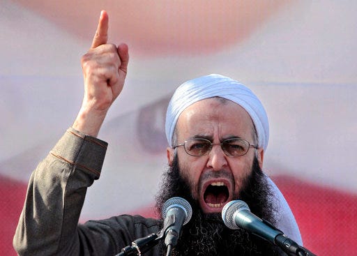 FILE - In this March 4, 2011 file photo, Sheikh Ahmad al-Assir, a Lebanese anti-Syrian regime leader, addresses his supporters during a demonstration against Syrian President Bashar Assad, at Martyrs Square in downtown of Beirut, Lebanon. On Thursday, Sept 28, 2017, a military judge is scheduled to issue a verdict in the case against Sheikh Ahmad al-Assir and 33 others on charges of fighting the Lebanese army in the southern city of Sidon in 2013. (AP Photo/Hussein Malla, File)