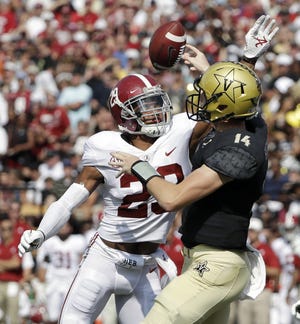 Alabama defensive back Minkah Fitzpatrick hits the arm of Vanderbilt quarterback Kyle Shurmur to force an incomplete pass during Saturday's game. [Mark Humphrey/The Associated Press]