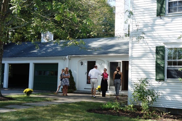 Martha Bohline, center, greets visitors during an open house at 46 Springdale Ave., Dover.