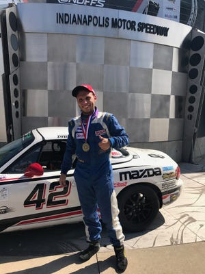 Preston Pardus poses in Indy Victory Lane after winning the SCCA Spec Miata national championship. [Dan Pardus]