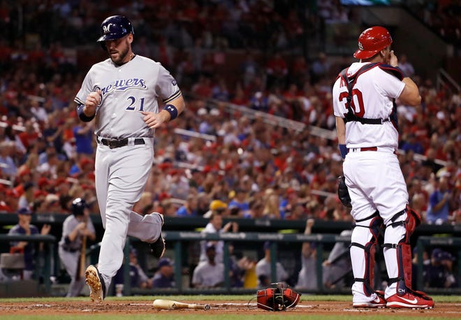 Milwaukee Brewers' Travis Shaw (21) scores past St. Louis Cardinals catcher Carson Kelly during the second inning of a baseball game Friday, Sept. 29, 2017, in St. Louis. (AP Photo/Jeff Roberson)