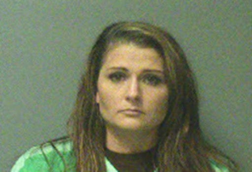 This photo provided by City of Johnston, Iowa shows Erin Macke.  Police have arrested Macke, a suburban Des Moines mother who left her four children home alone while she traveled to Europe. Johnston police have charged Macke, 30, with four counts of child endangerment and one of transferring a firearm to a person under 21. Police said the latter charge was filed because a firearm was within reach of the children in the home. (City of Johnston, Iowa via AP)