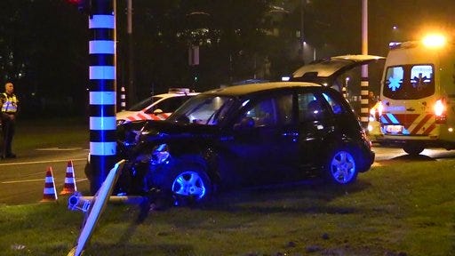 This image taken from video shows a car crashed up against a lamp post in Amsterdam, Thursday Sept. 28, 2017. Manchester City striker Sergio Aguero has been injured in a road accident in the Netherlands, the English Premier League club said Friday. (KaWijKo Media via AP)