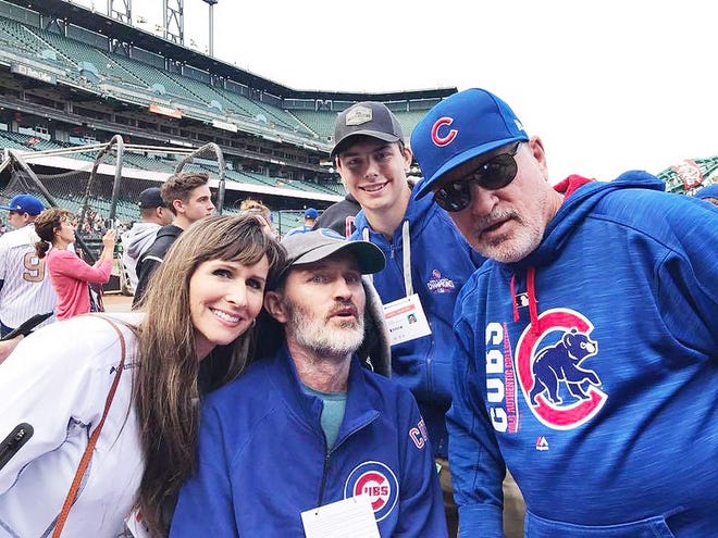 Pontiac native and right-to-try law advocate Mike DeBartoli, center, is flanked by his wife, Gina, and Cubs Manager Joe Maddon at a baseball game this year.