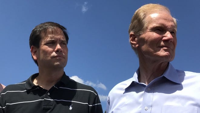 Florida Sens. Marco Rubio (left) and Bill Nelson, shown here in Belle Glade after Hurricane Irma, issued separate calls on Thursday for a greater military role in coordinating Hurricane Maria relief in Puerto Rico. (George Bennett/The Palm Beach Post)