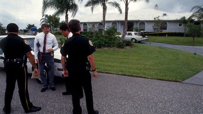 May 26, 1990: Palm Beach County detectives examine the doorway where someone dressed as a clown shot and killed Marlene Warren in Wellington. 27 years later, Sheila Keen-Warren has been charged in the crime. (Sherman Zent / The Palm Beach Post)