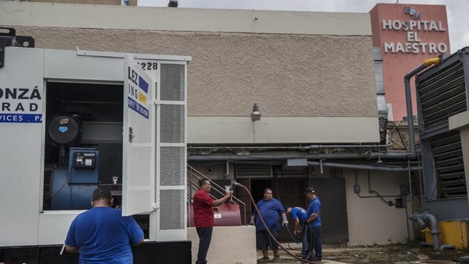 SAN JUAN, Puerto Rico — Workers set up a second generator at Hospital El Maestro in on Tuesday. Investors holding bonds issued by the island’s power company have offered Puerto Rico a $1 billion loan to pay for urgent repairs. (Victor J. Blue/The New York Times)