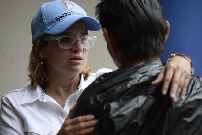 San Juan Mayor Carmen Yulin Cruz, left, arrives at a hospital during the evacuation of patients after a power-plant failure in San Juan, Puerto Rico, on Saturday. [The Associated Press / Carlos Giusti]