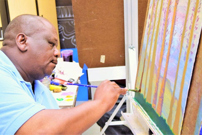 Jonathan Lang paints trees in a class for veterans at Jepson Center for the Arts. (Leslie Moses/For Savannah Morning News)