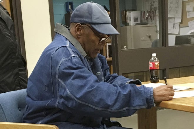 Former football star O.J. Simpson signs documents at the Lovelock Correctional Center, in Nevada, just before his release early Sunday. [Brooke Keast / Nevada Department of Corrections via AP]
