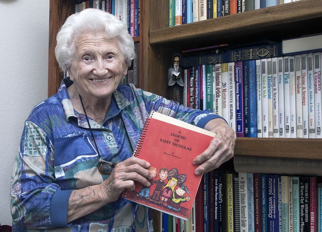 CHIEFTAIN PHOTO/JOHN JAQUES Bernice Krasovec holds the children's book, 'A Legend of Saint Nicholas," she wrote at the request of the Rev. Blane Bebble at St. Mary Hope of Christian Church. Krasovec is being honored at this year's Slovenian Dinner for her service to the Slovenian community.