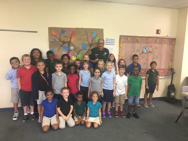 Volusia County Sheriff Mike Chitwood visited the Four Townes Family YMCA Afterschool care program on Thursday, Sept. 21, located at Deltona Presbyterian Church. Sheriff Chitwood was greeted by over 20 Kids who had a lot of questions for him. The Y kids asked him questions for close to an hour about what it’s like to be a police officer. Pictured, Sheriff Chitwood with the Y kids. [Photo provided]