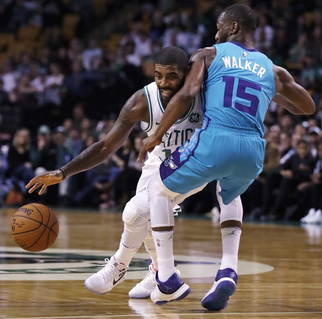 Boston Celtics guard Kyrie Irving, left, tries to drive past Charlotte Hornets guard Kemba Walker during the first quarter of Monday's preseason game in Boston. [AP/Charles Krupa]