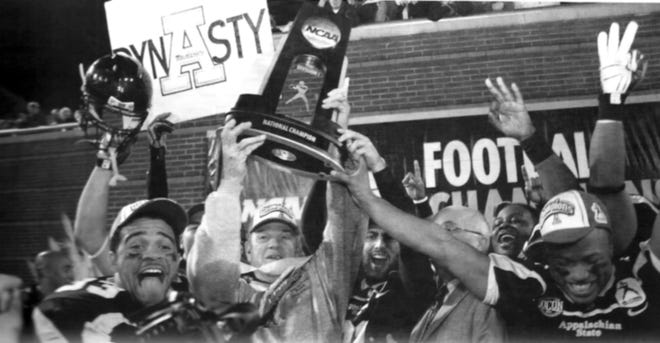 Gastonia's Josh Jackson (far left), Appalachian coach Jerry Moore (holding trophy) and Gastonia's Julian Rauch (to the left of Moore) celebrate the Mountaineers' 2007 FCS national championship in Chattanooga, Tenn. [2008 ASU media guide photo]