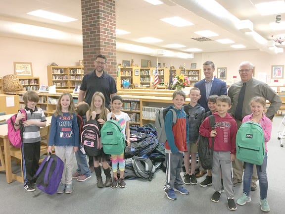 Third graders at Cedarville Elementary School were joined by State Rep. Lee Chatfield and officials from AT&T as they helped move 75 backpacks filled with school supplies into the school library. The backpacks were donated by AT&T Pioneers and will be distributed to Cedarville students in need.