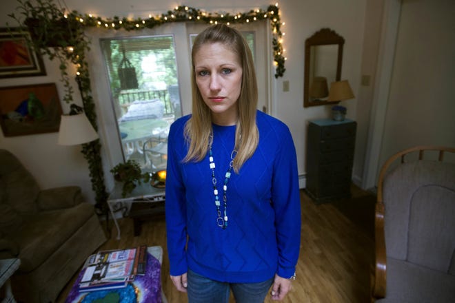 Julie Eldred poses for a photo in her Massachusetts home. Eldred, 29, tested positive for the opioid fentanyl less than two weeks after a court ordered her to refrain from drugs while on probation for larceny. She spent the next 10 days in jail until her lawyer could find her a bed in a treatment facility. On Monday, Massachusetts' highest court was to hear her case challenging the practice of ordering people with addiction to stay drug free as a condition of probation. [JESSE COSTA/WBUT via AP]