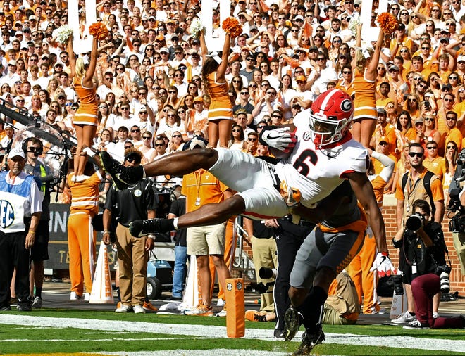 Georgia wide receiver Javon Wims catches a touchdown pass over Tennessee defensive back Shaq Wiggins during the first half an NCAA college football game against Tennessee on Saturday, Sept. 30, 2017, in Knoxville, Tenn. (Joy Kimbrough/The Daily Times via AP)