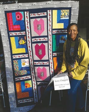Accomplished actress, comedian and auirky crafter Katsy Chappell stands beside her self-designed “LOL” quilt that was top-stitched by local Tangled Thread’s quilt shop owner Wanda Jones. Chappell is delighted to be joining a start-studded lineup this weekend to celebrate the PHS All-School Reunion beginning Friday.