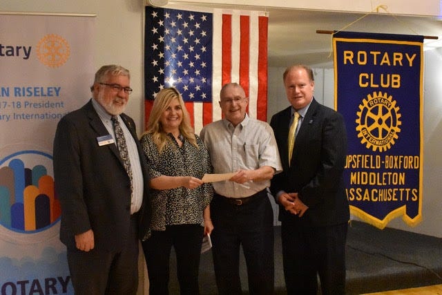 Rotarian Cheryl Crowley of the Breakaway Restaurant in Danvers presents a check for $5,000 to TBM Rotary Treasurer Bill Shannon for Hurricane Harvey relief. Pictured, from left: Rotary District 7930 Gov. David Gardner, Crowley, Shannon and TBM Rotary President Dan Mackey. [Courtesy Photo]