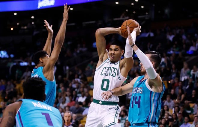 Boston Celtics forward Jayson Tatum is pressured by Charlotte Hornets forward Michael Kidd-Gilchrist as he looks to pass during the first quarter Monday.