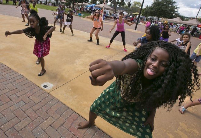 Tikoah Youmans, right, competes in a dance contest at the 2015 Ocala Cultural Festival. This year's festival runs Saturday at Tuscawilla Park. [Doug Engle/File photo]