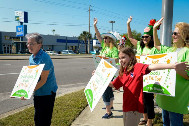 In this March 2014 photo, supporters of Sarasota County schools' 1-mill tax extension wave signs to drivers on U.S. 41 near Phillippi Shores Elementary School. [Herald-Tribune Archive]