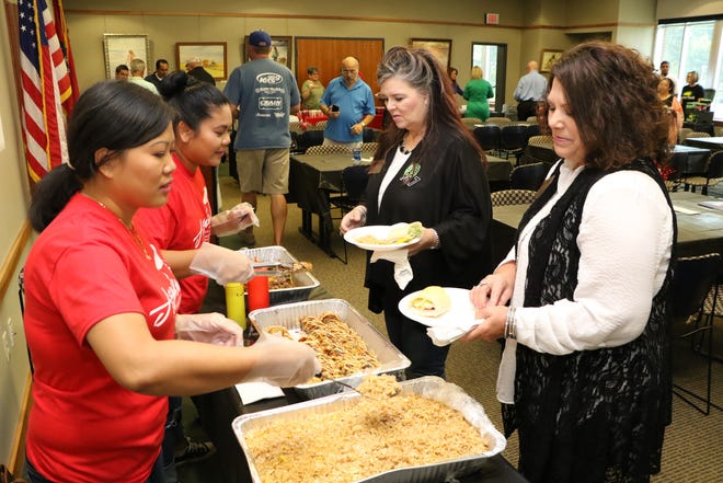 Dara Harlany, left, and Panyda Jones with Asuka, serve lunch samples to Delanna Nutter of MIX 105.1, right, and Pam Cloud with Life 98.7 on Sept. 19 during the Altrusa TASTE of Fort Smith preview lunch in the Community Room at the Fort Smith Public Library. The annual TASTE of Fort Smith fundraiser will be Oct. 24 at the Fort Smith Convention Center and will benefit Literacy Council of Western Arkansas; Crawford County Volunteers for Literacy; Fort Smith Public Libray; Sebastian County Humane Society; Curt, Cliff and Opal Young Children's Home; and Scott-Sebastian Regional Library. This year's participants include the area's finest restaurants, food trucks, caterers and food and beverage purveyors with lunch from 11 a.m. to 1 p.m. and dinner from 5-7 p.m. [JAMIE MITCHELL/TIMES RECORD]