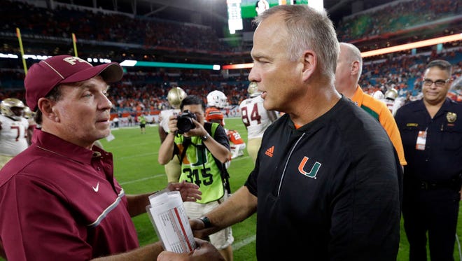 Florida State head coach Jimbo Fisher (left) Miami head coach Mark Richt shake hands after the Seminoles beat the Hurricanes 20-19 last year in Miami Gardens. Richt, a former FSU assistant under Bobby Bowden, will coach UM in Tallahassee for the first time on Saturday. (AP Photo/Wilfredo Lee, File)