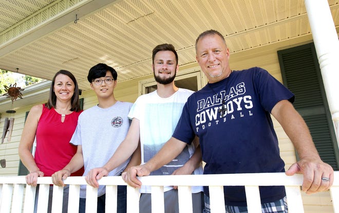 Mindy Stewart, left, and her husband, Gary Stewart, right, are hosting exchange students Hee-Won Lee, from South Korea, and Johannes Zier, from Germany. [JOHN CLARK/THE GASTON GAZETTE]