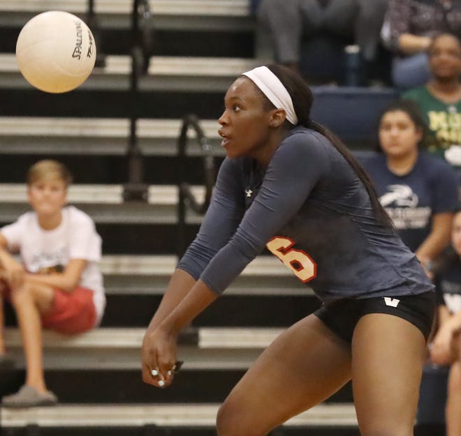 Vanguard's Eboni Harris digs the ball against Forest during a match Sept. 21. The senior and Alabama commit has overcome major knee surgery to pace her team this season. [Bruce Ackerman/Staff photographer]