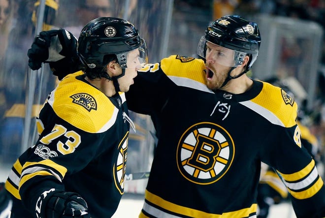 Boston's Charlie McAvoy (73) celebrates a goal with Kevan Miller during the second period of Thursday's season opening game against the Nashville Predators in Boston.