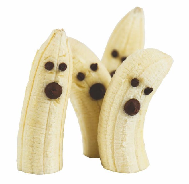 Decorate banana halves with spooky faces