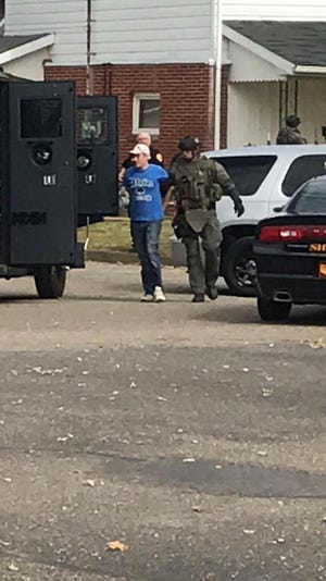 Photo courtesy of Aaron Bitikofer 

Police take a suspect into custody Wednesday in connection with the robbery of the Citizens Bank in Strasburg.