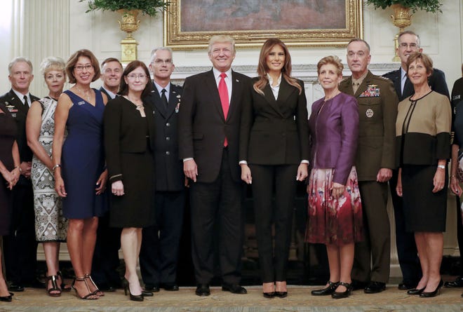 President Donald Trump and first lady Melania Trump, center, poses for a group photo with senior military leaders and spouses in the State Dining Room of the White House in Washington, Thursday, Oct. 5, 2017. Trump was hosting the dinner for the group. (AP Photo/Pablo Martinez Monsivais)