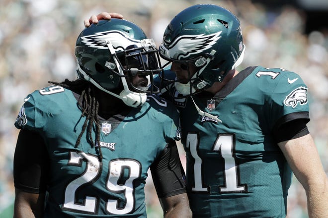 FILE - In this Sunday, Sept. 24, 2017, file photo, Philadelphia Eagles' LeGarrette Blount, left, and Carson Wentz celebrate during the first half of an NFL football game against the New York Giants in Philadelphia. Closing out close games is an art the Eagles are learning. After going 1-5 in games decided by a touchdown or less in 2016, the Eagles already are 2-1 in such games this season. (AP Photo/Michael Perez, File)
