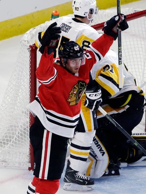 Chicago Blackhawks left wing Brandon Saad celebrates after scoring his first goal during the first period of an NHL hockey game against the Pittsburgh Penguins, Thursday, Oct. 5, 2017, in Chicago. (AP Photo/Nam Y. Huh)