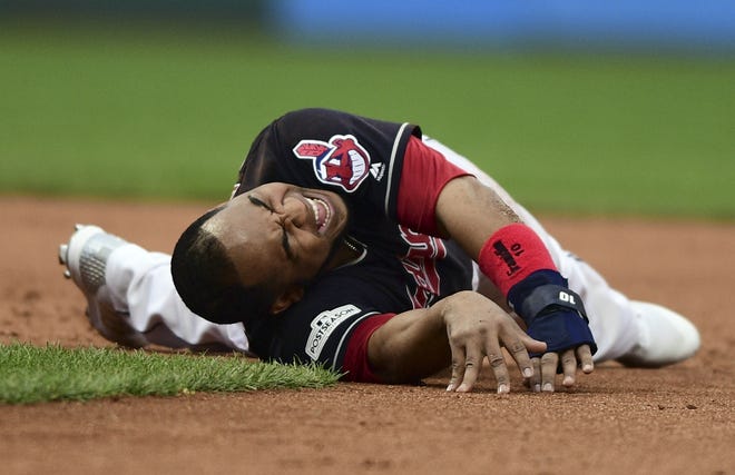 The Cleveland Indians' Edwin Encarnacion grimaces after rolling his ankle trying to get back to second base in the second inning against the New York Yankees in Game 2 of the American League Division Series, Friday, in Cleveland. [THE ASSOCIATED PRESS / DAVID DERMER]
