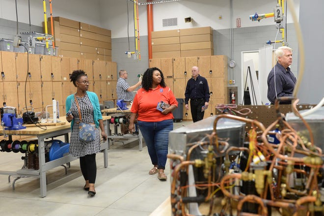 Community members walk through the heating and cooling technology classroom at Alamance Community College's new Advanced Applied Technolgy Center on Oct.6.

[Steven Mantilla/Times-News]
