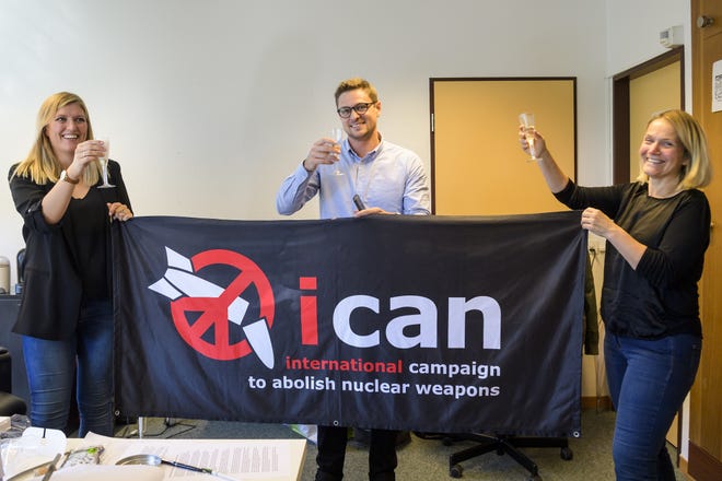 Beatrice Fihn, from left, executive director of the International Campaign to Abolish Nuclear Weapons (ICAN), Daniel Hogsta and Grethe Ostern, members of the steering committee, celebrate with champagne Friday at the headquarters of the International Campaign to Abolish Nuclear Weapons (ICAN), in Geneva, Switzerland. The International Campaign to Abolish Nuclear Weapons (ICAN) is the winner of this year's Nobel Peace Prize. [The Associated Press]