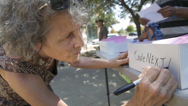 Linda Curtis, petition manager and founder of the new political action committee IndyAustin, prepares handouts for the public at a petition drive last month for a referendum on CodeNext.