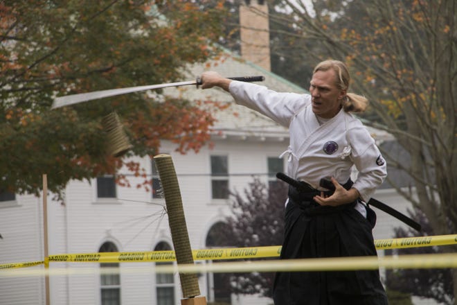 Joshua Hatcher of Akido of Bristol County demonstrates his swordsmanship. Later in the demonstration, he explained how sword work ties into hand-to-hand combat in this form of martial arts. [MONTANA SAMUELS/STANDARD-TIMES/SCMG]