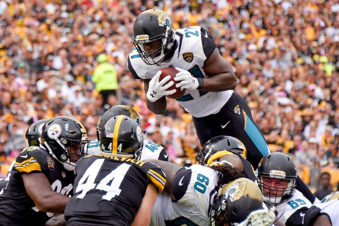 Jacksonville’s Leonard Fournette goes over Pittsburgh’s defense to score a touchdown in the second quarter. (Don Wright/AP Photo)
