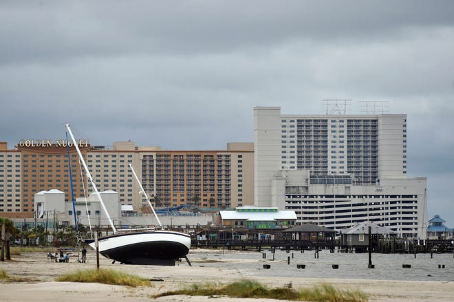 A sail boat is beached near Margaritaville and the Golden Nugget in Biloxi, Miss., Sunday, Oct. 8, 2017, after Hurricane Nate made landfall on the Gulf Coast. (Justin Sellers/The Clarion-Ledger via AP)
