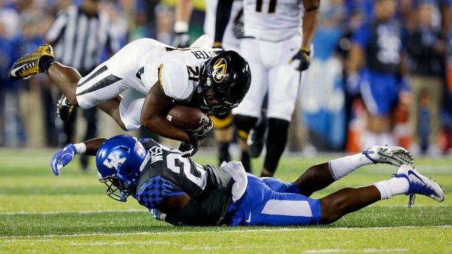 Missouri running back Ish Witter, top, is tackled by Kentucky safety Darius West during the first half of an NCAA college football game Saturday, Oct. 7, 2017, in Lexington, Ky.